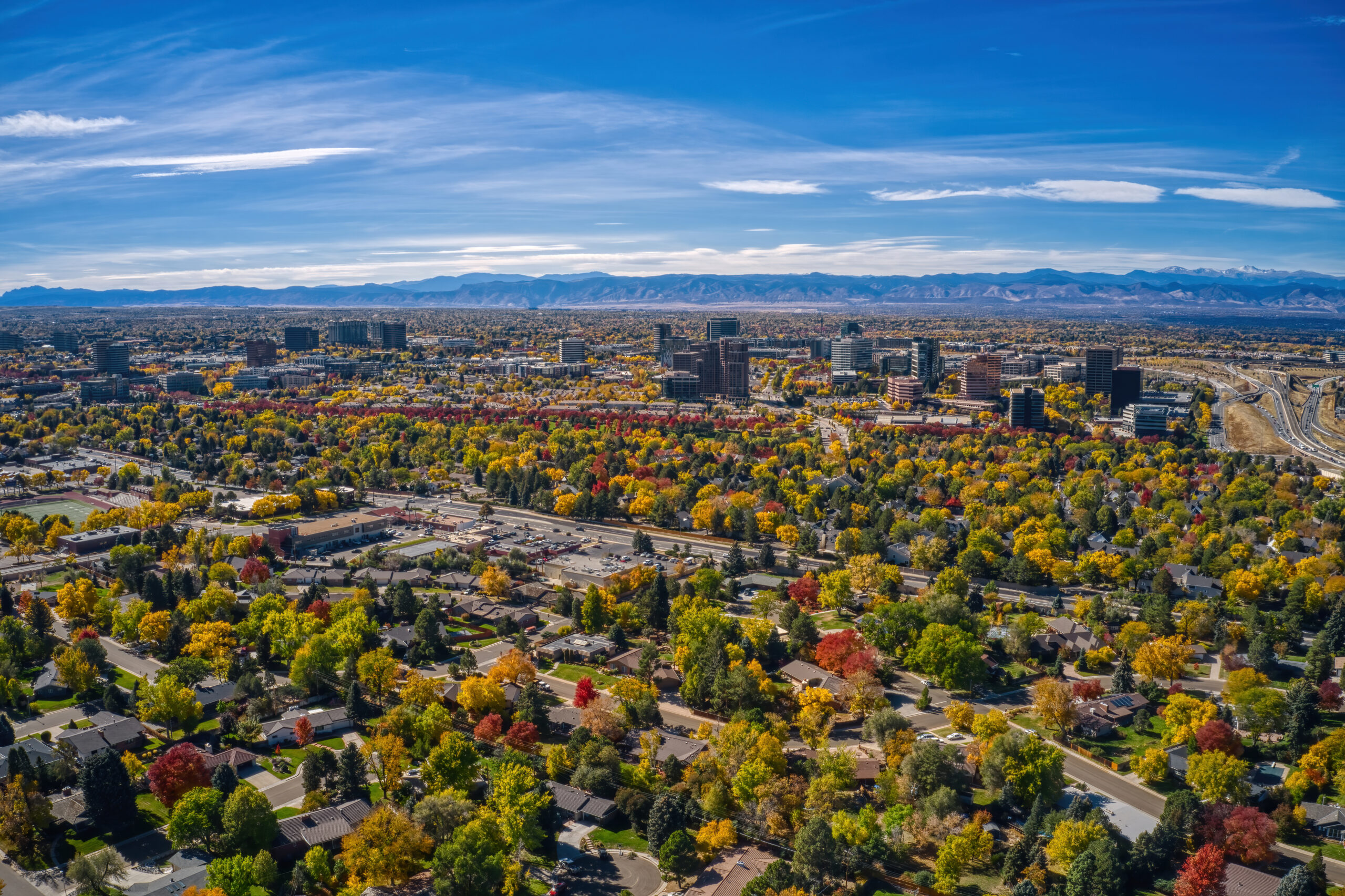 Residential homes in Aurora, Colorado with mountain views in the background.