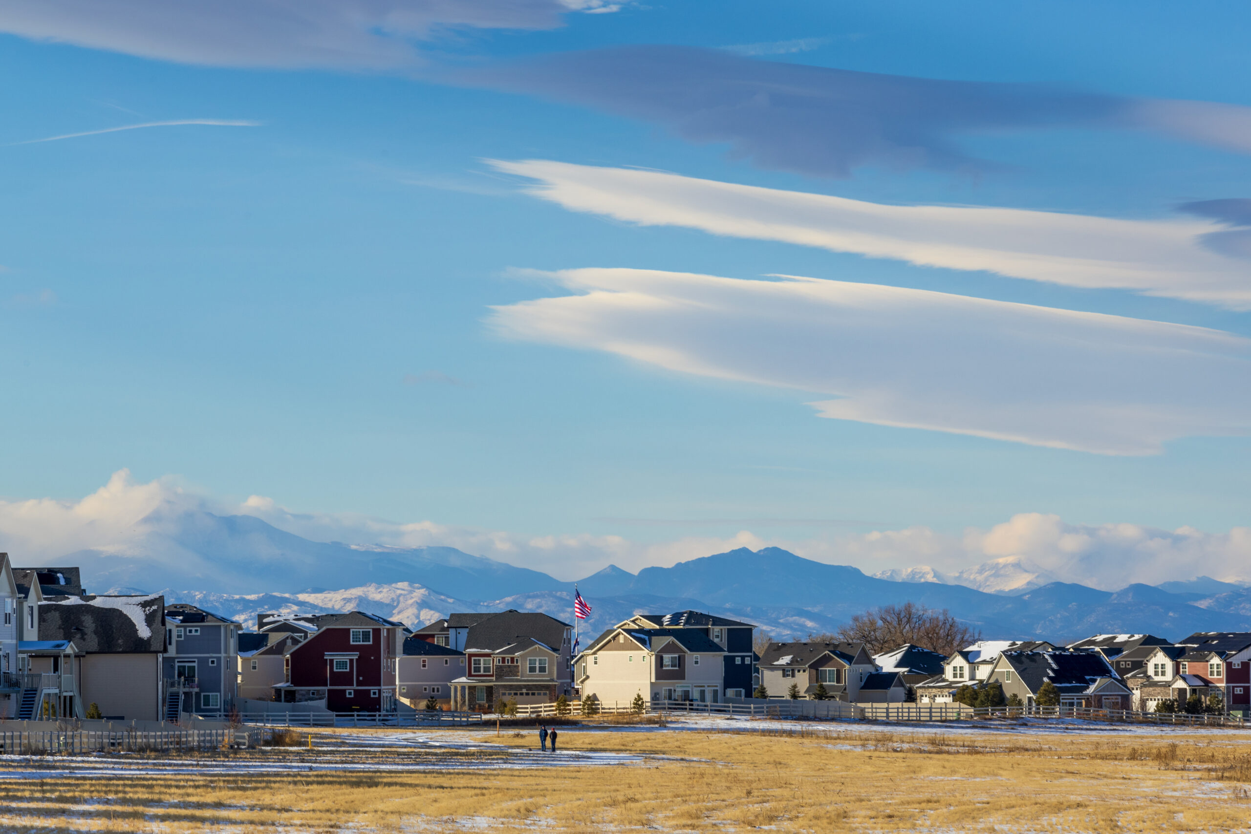 A scenic view of Commerce City, Colorado, showcasing residential neighborhoods under a clear blue sky